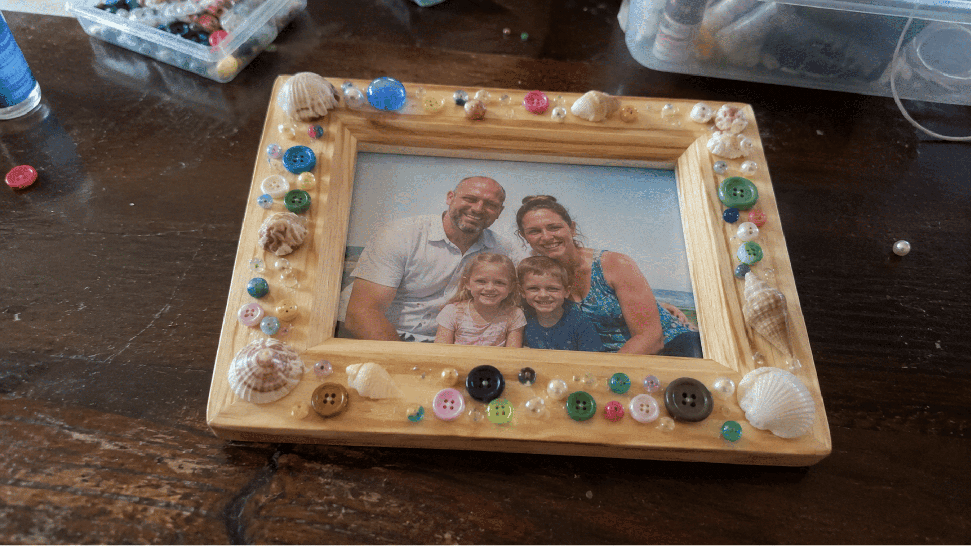 DIY photo frame decorated with buttons and seashells.