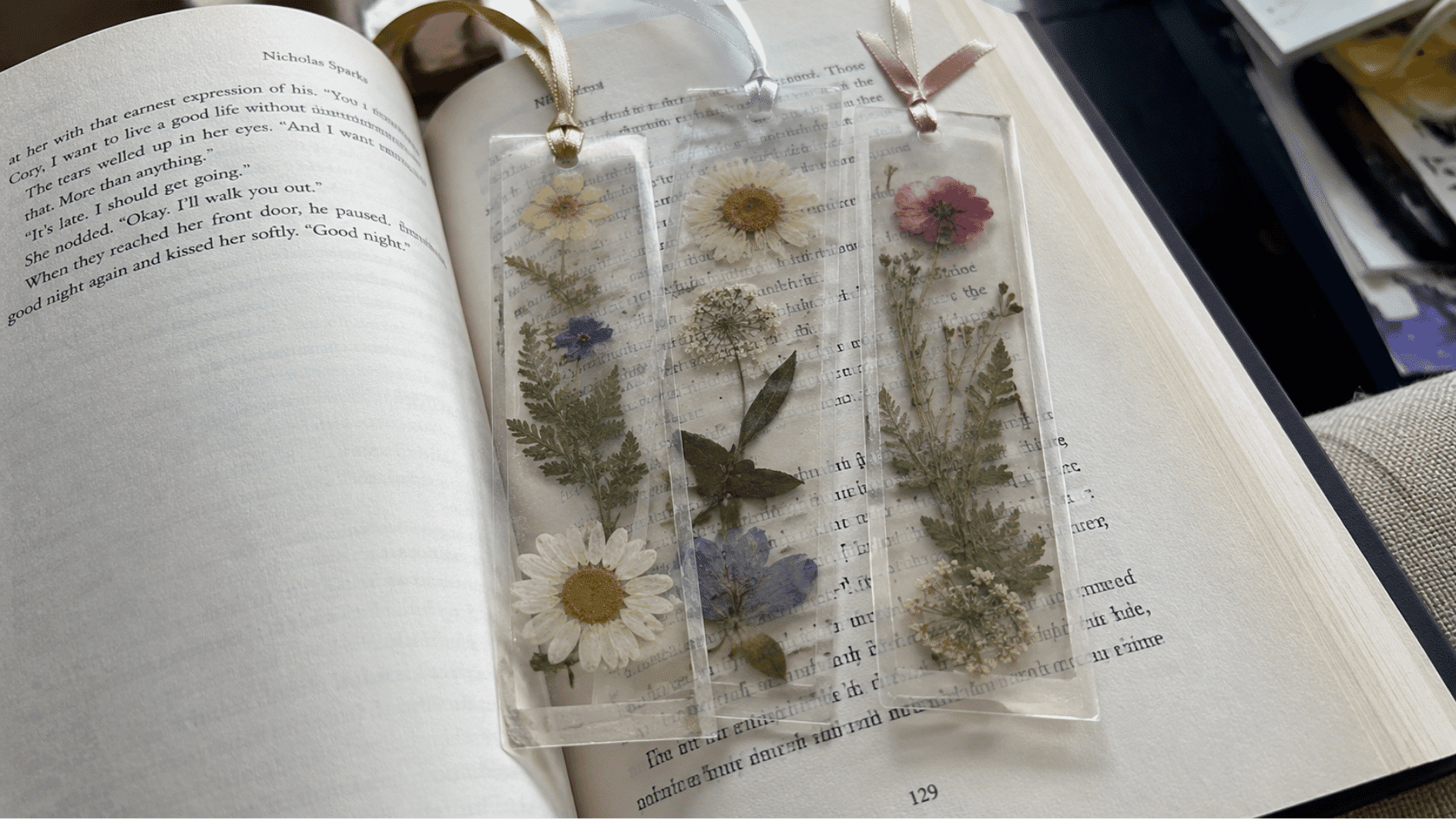 Pressed flower bookmarks resting on an open book