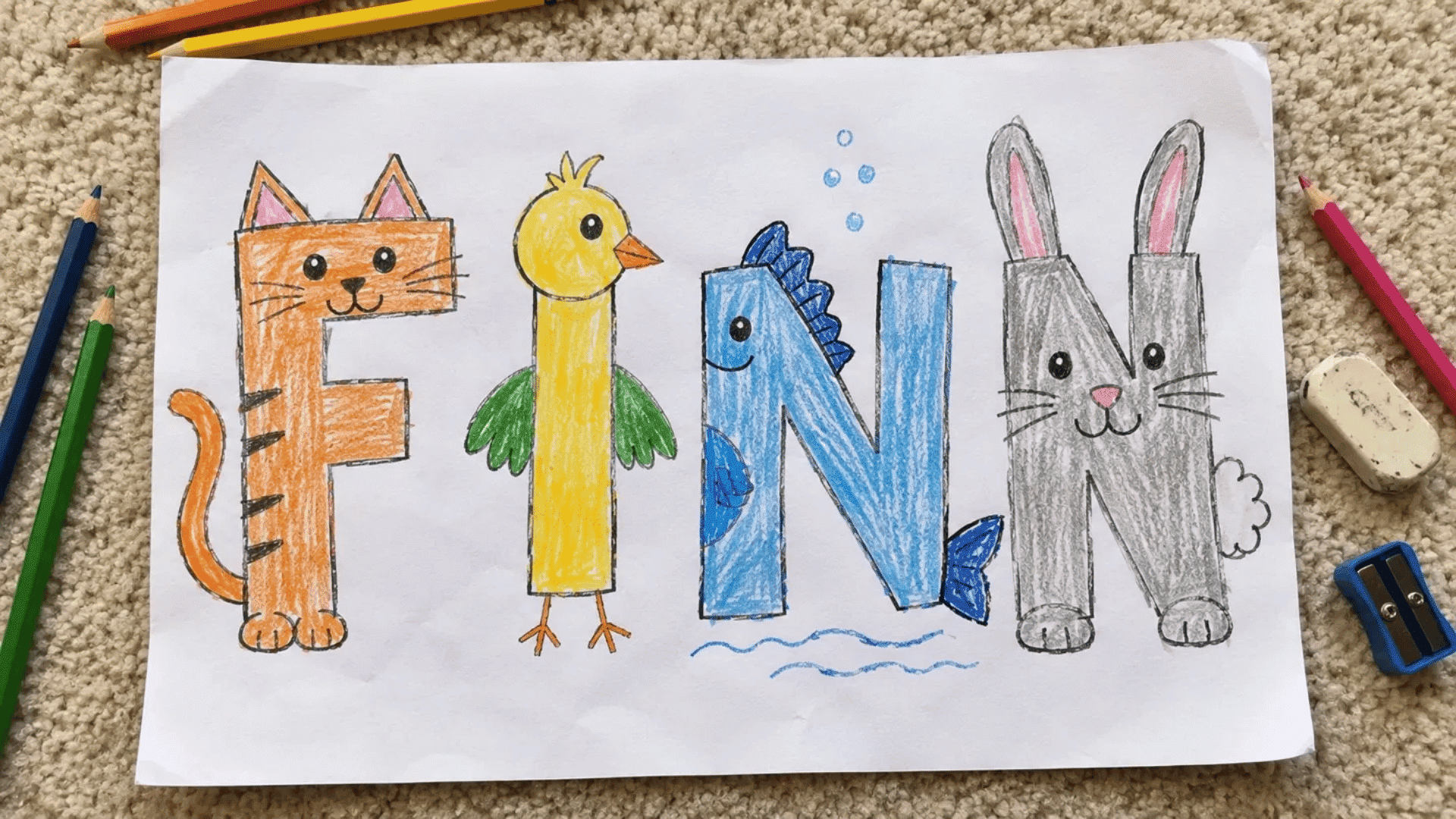 animal themed name art with cat bird fish and rabbit letters on beige carpet