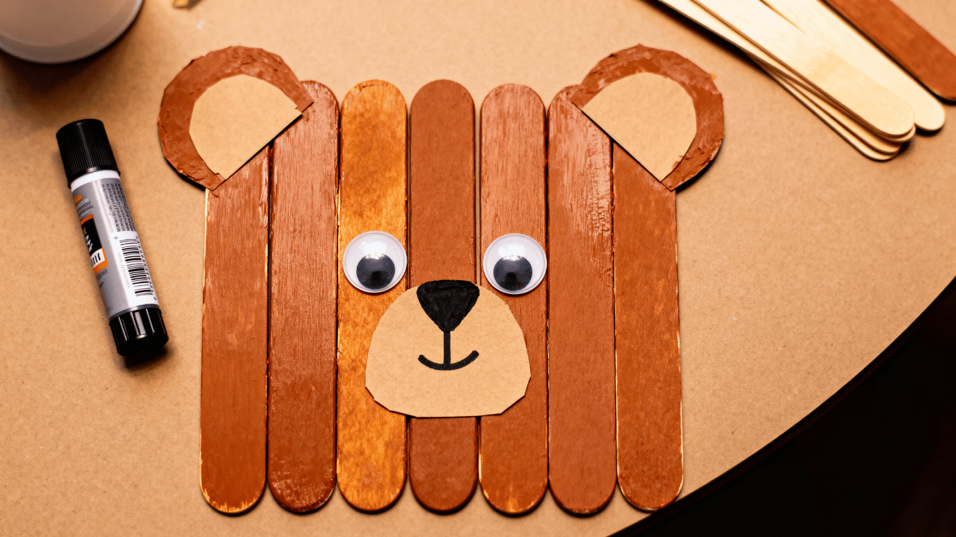 bear animal face craft made with popsicle sticks paper ears and googly eyes