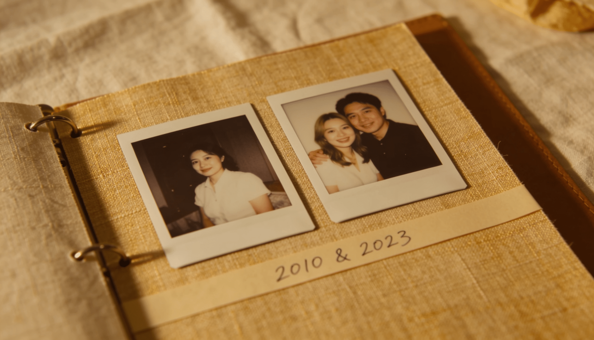 before-and-after scrapbook layout featuring two polaroid-style photos side by side, showing memories from different years on a linen-covered album page surface