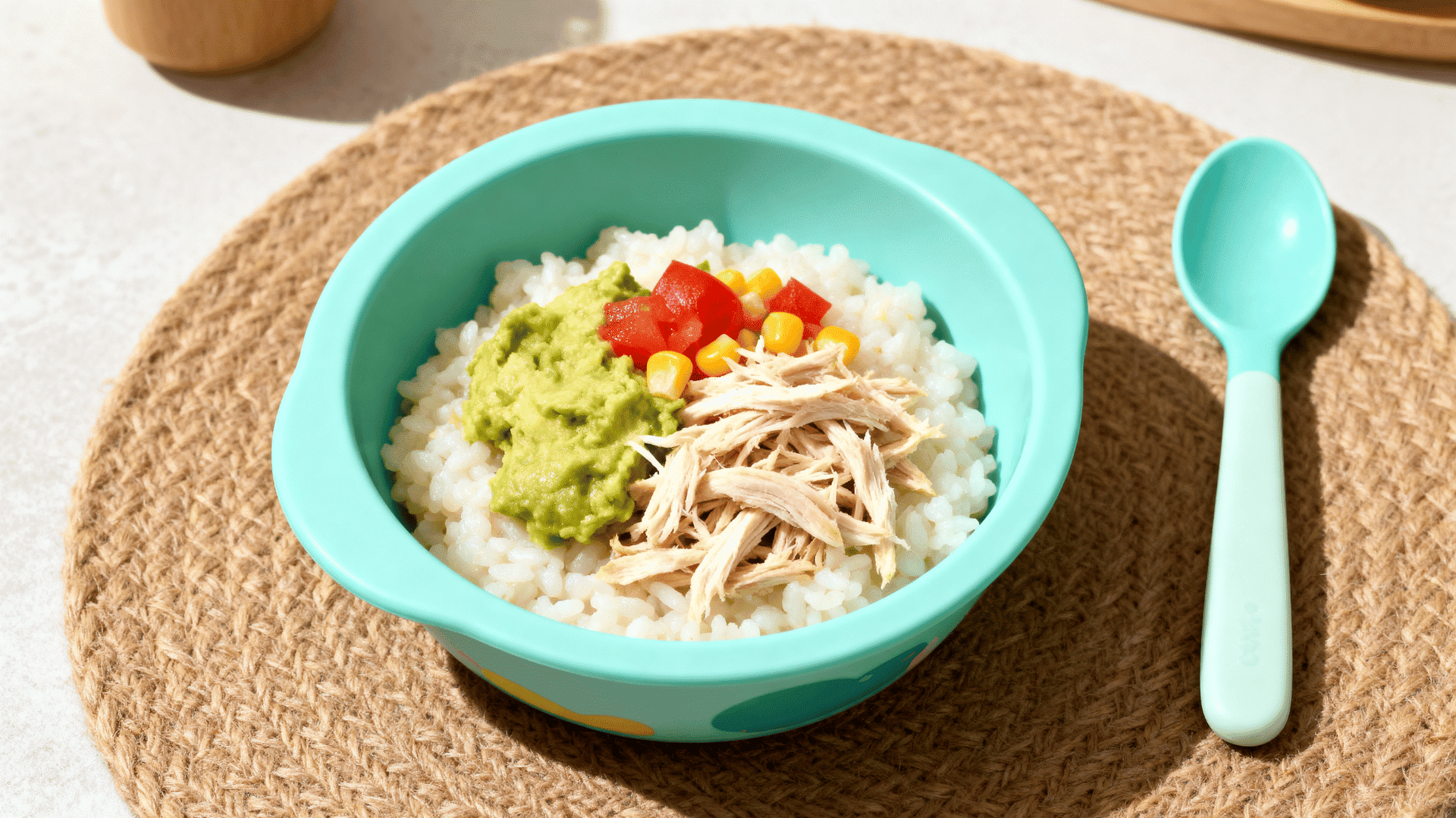 chicken rice and avocado bowl with corn in a small toddler serving