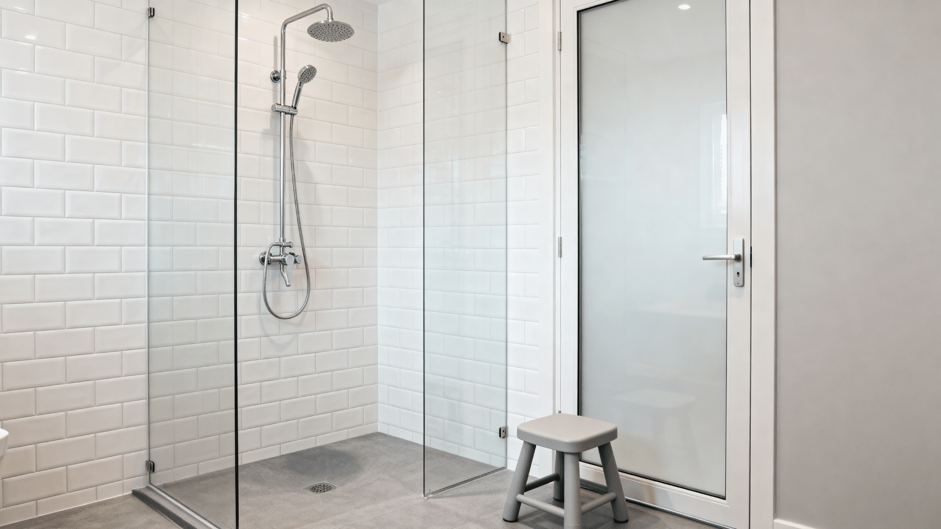compact shower with handheld showerhead on an adjustable rail