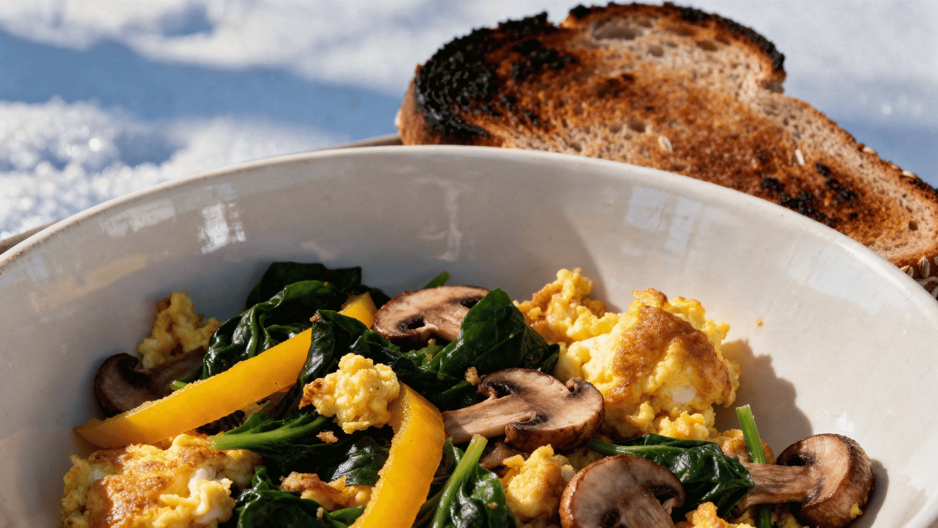 egg and veggie scramble with spinach, peppers, mushrooms, and toast on the side