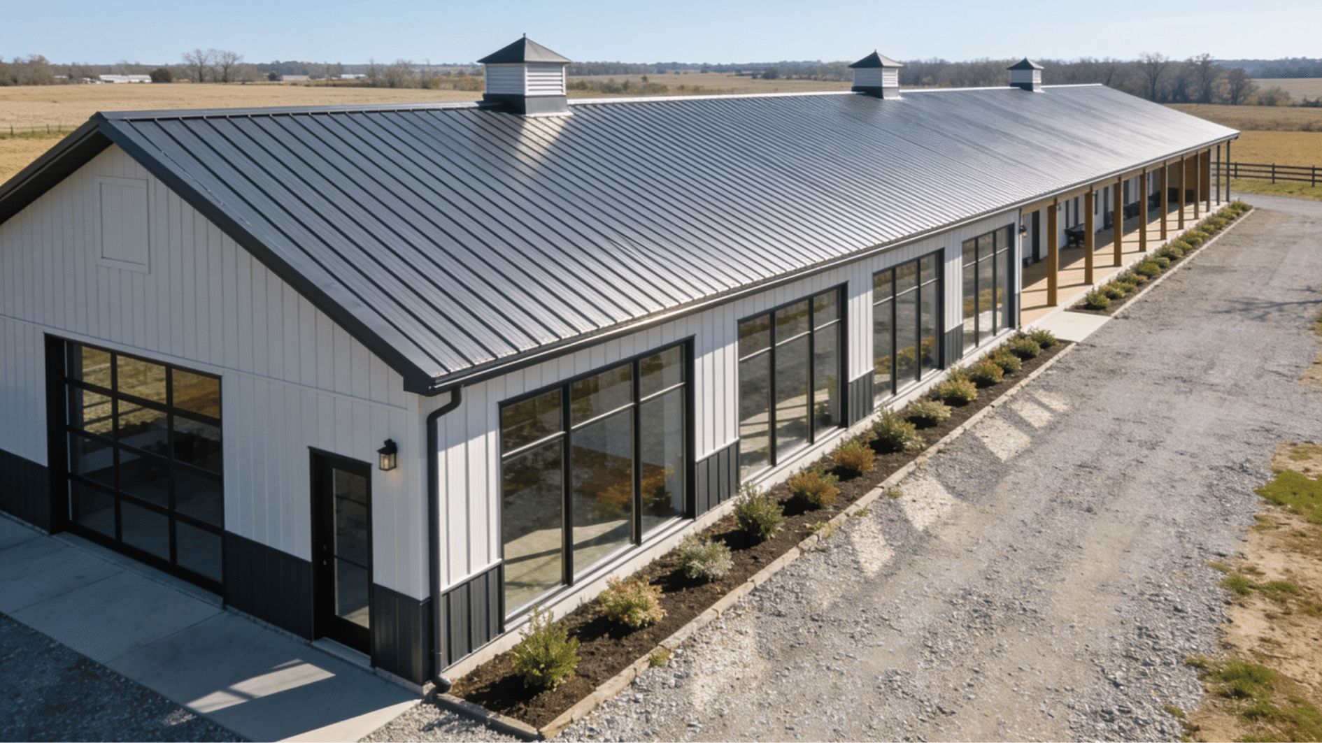 long narrow barndominium with modern barn styling large windows and open surroundings