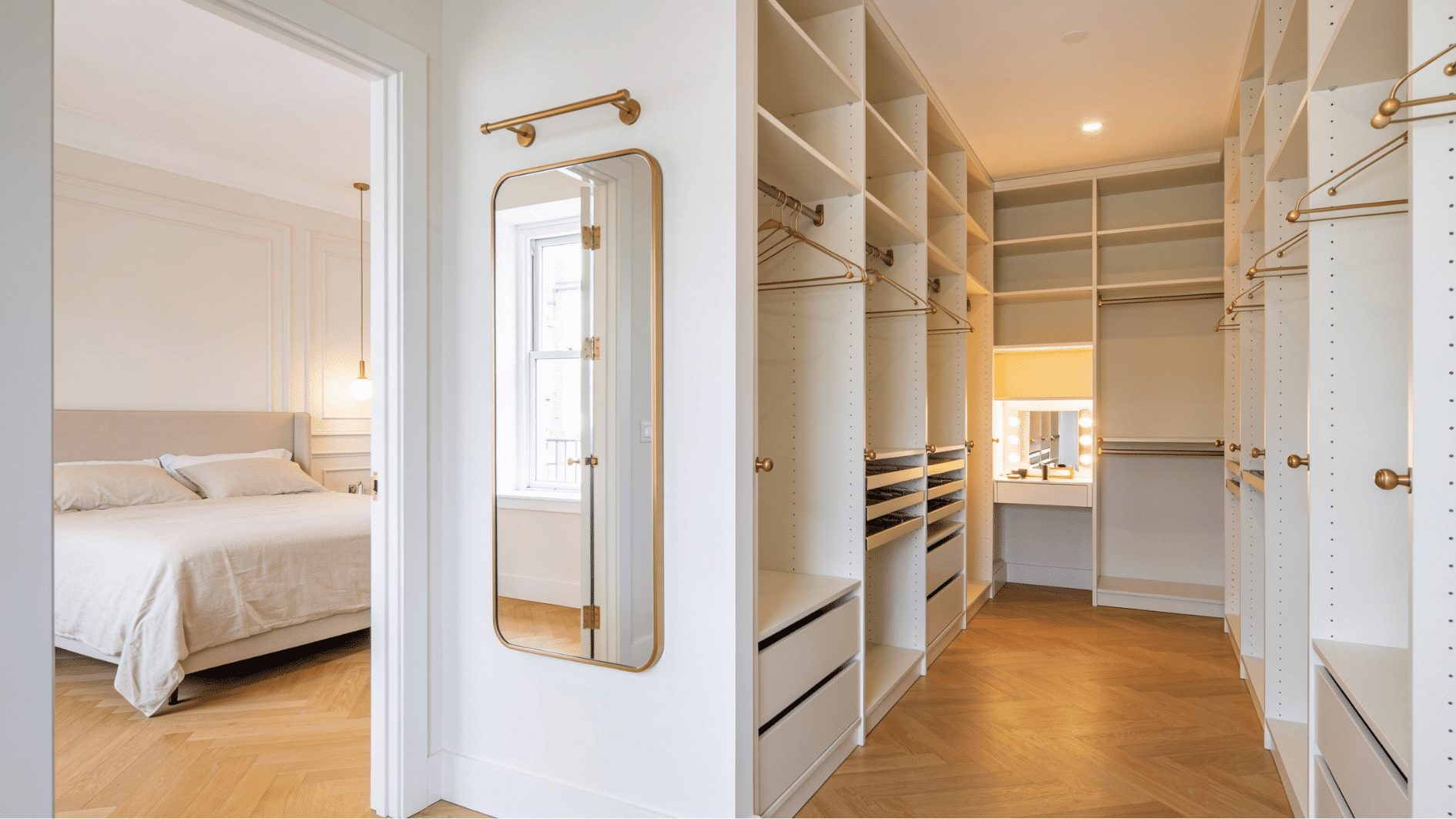master bedroom with open walkthrough to bright walk-in wardrobe with brass fittings and full length mirror