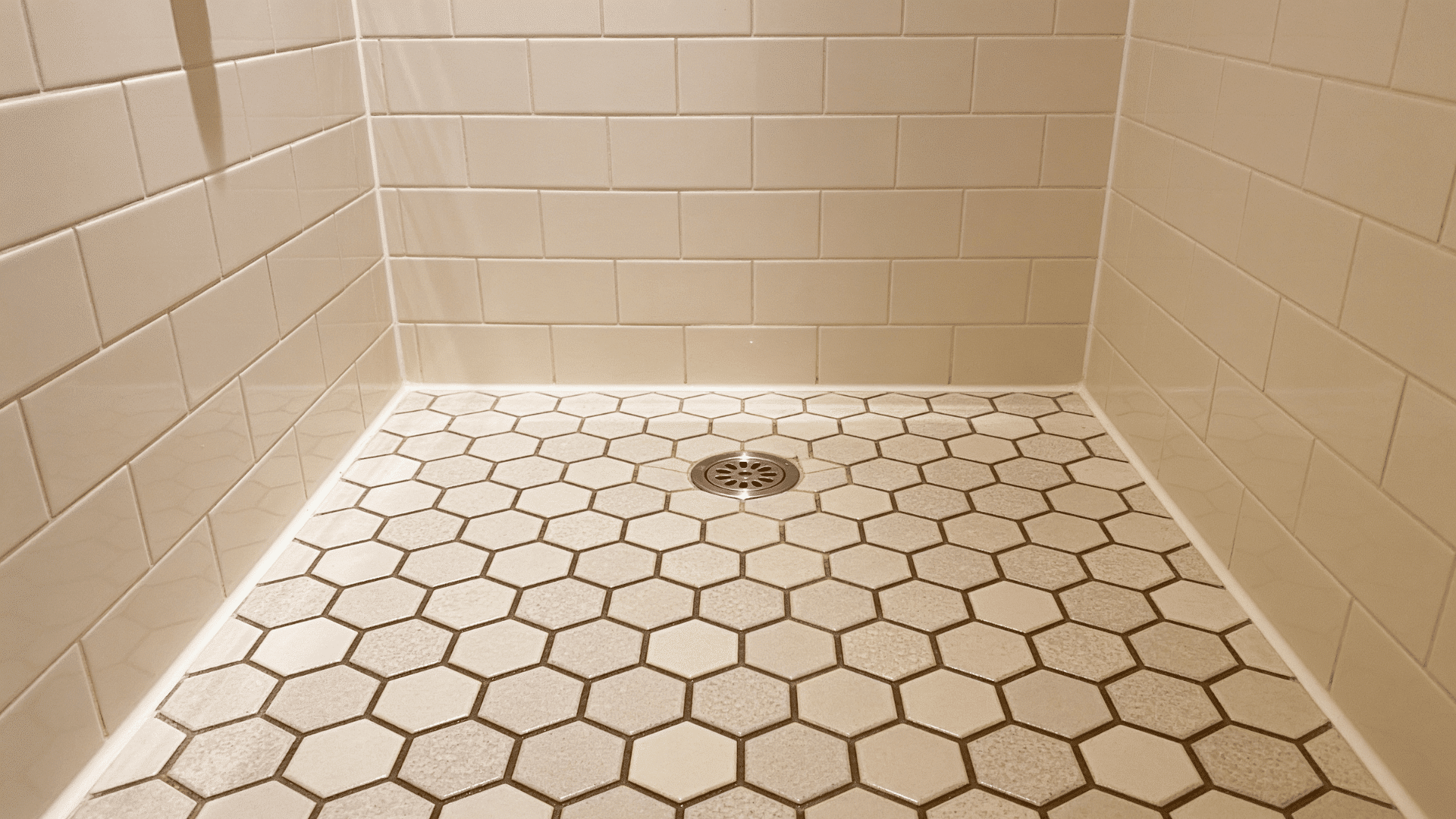 small shower floor with matte hexagon mosaic tile for better grip
