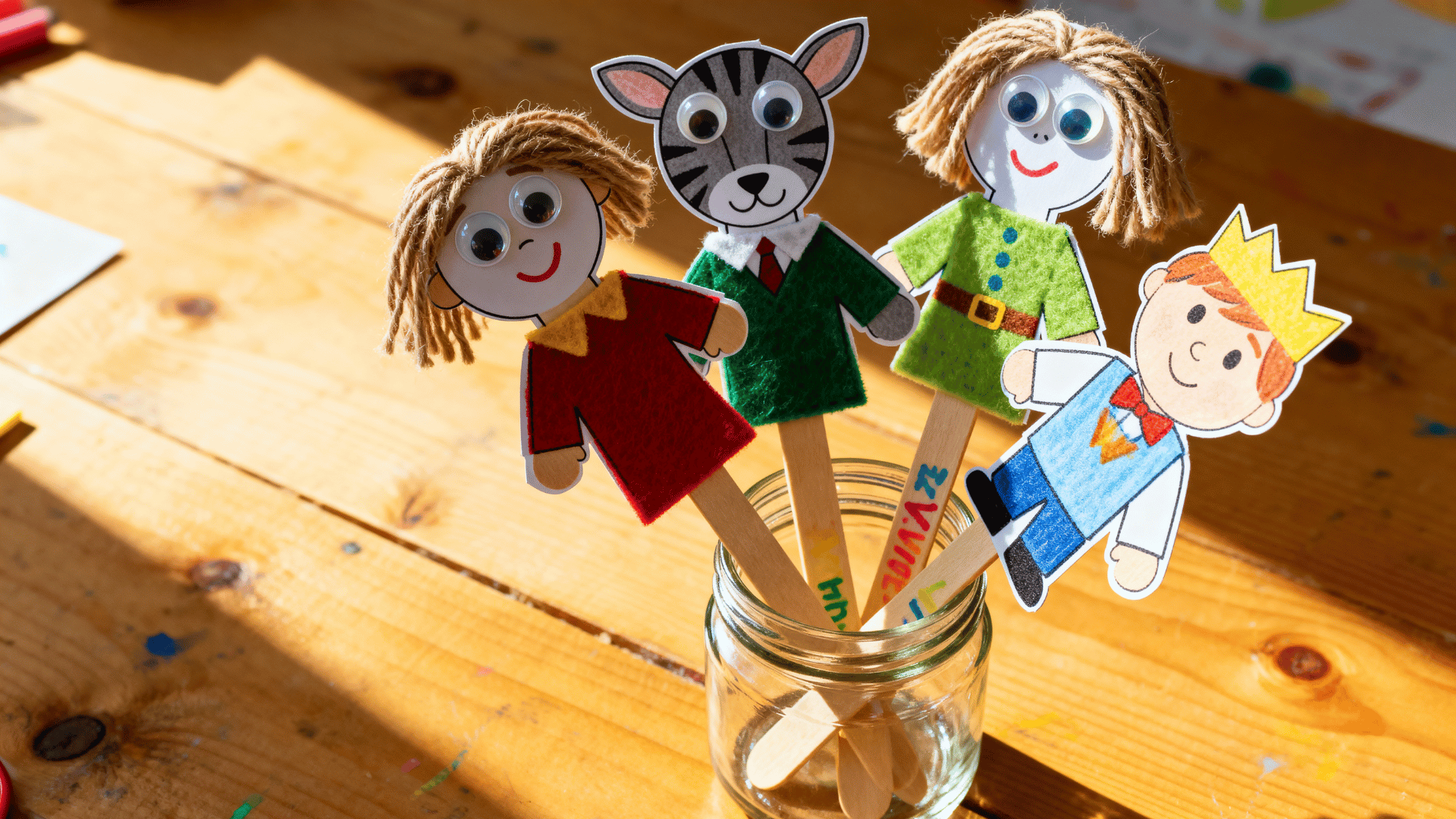 stick puppets with paper cutouts yarn hair felt clothing and popsicle stick handles