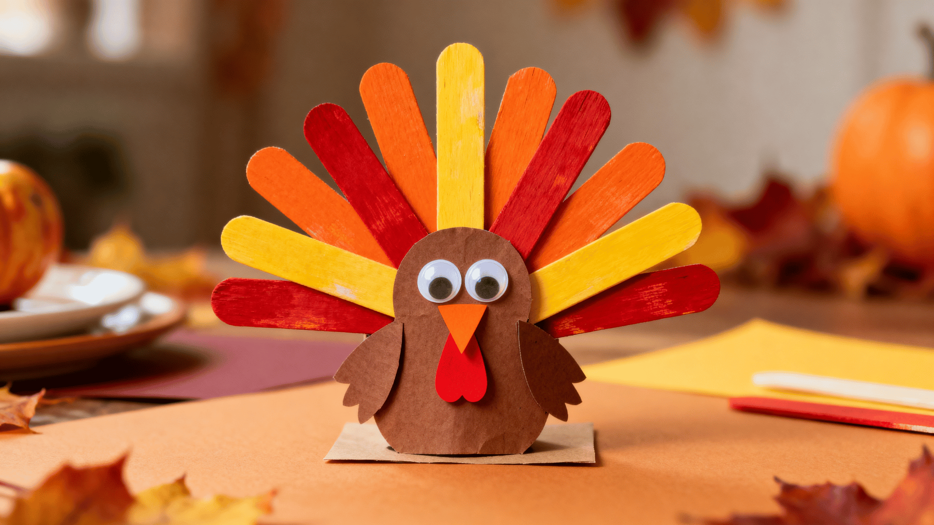 thanksgiving turkey craft with painted popsicle stick feathers and paper body
