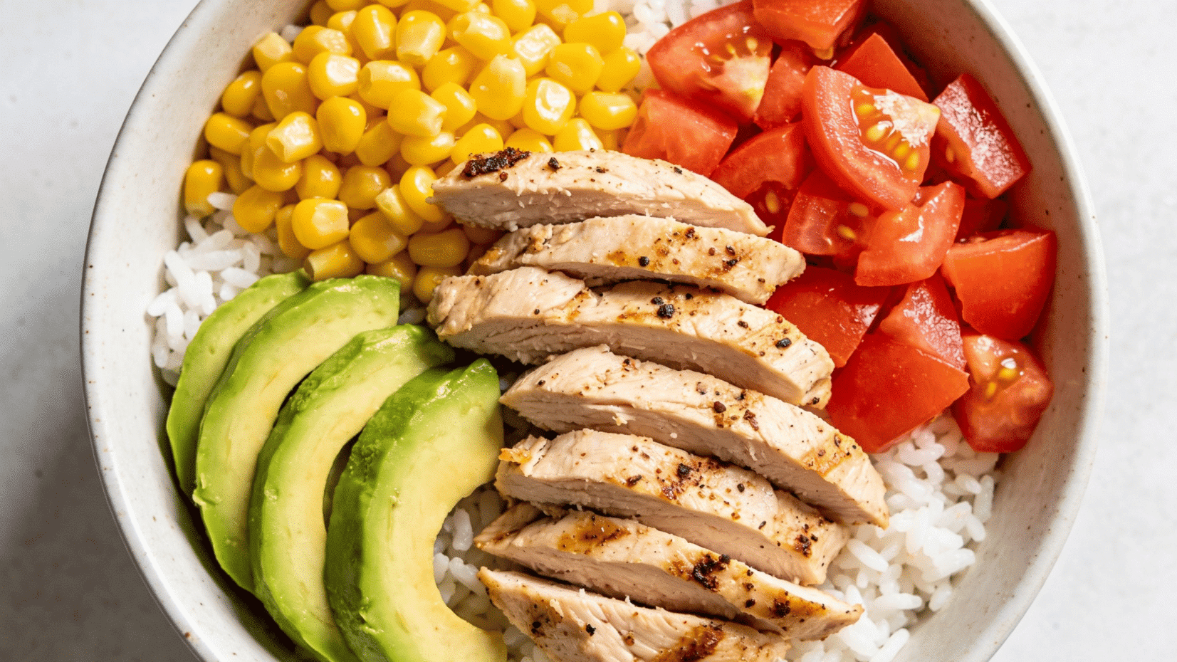 turkey and avocado rice bowl with corn and tomatoes