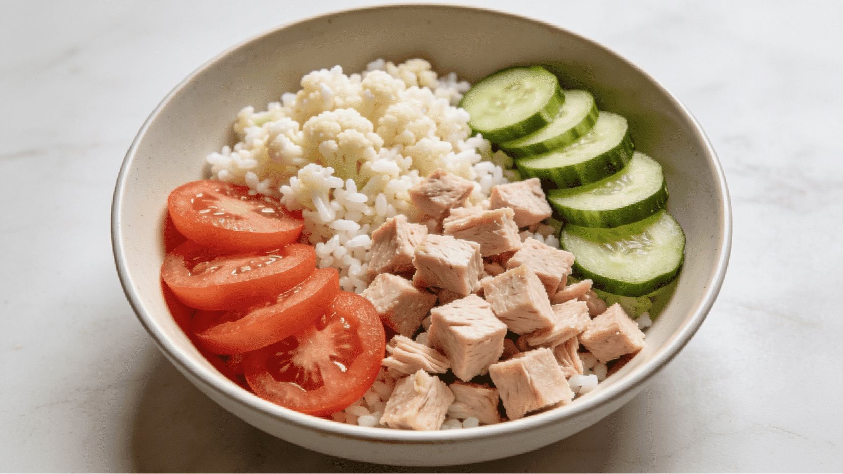 turkey and cauliflower rice bowl with tomatoes and cucumber