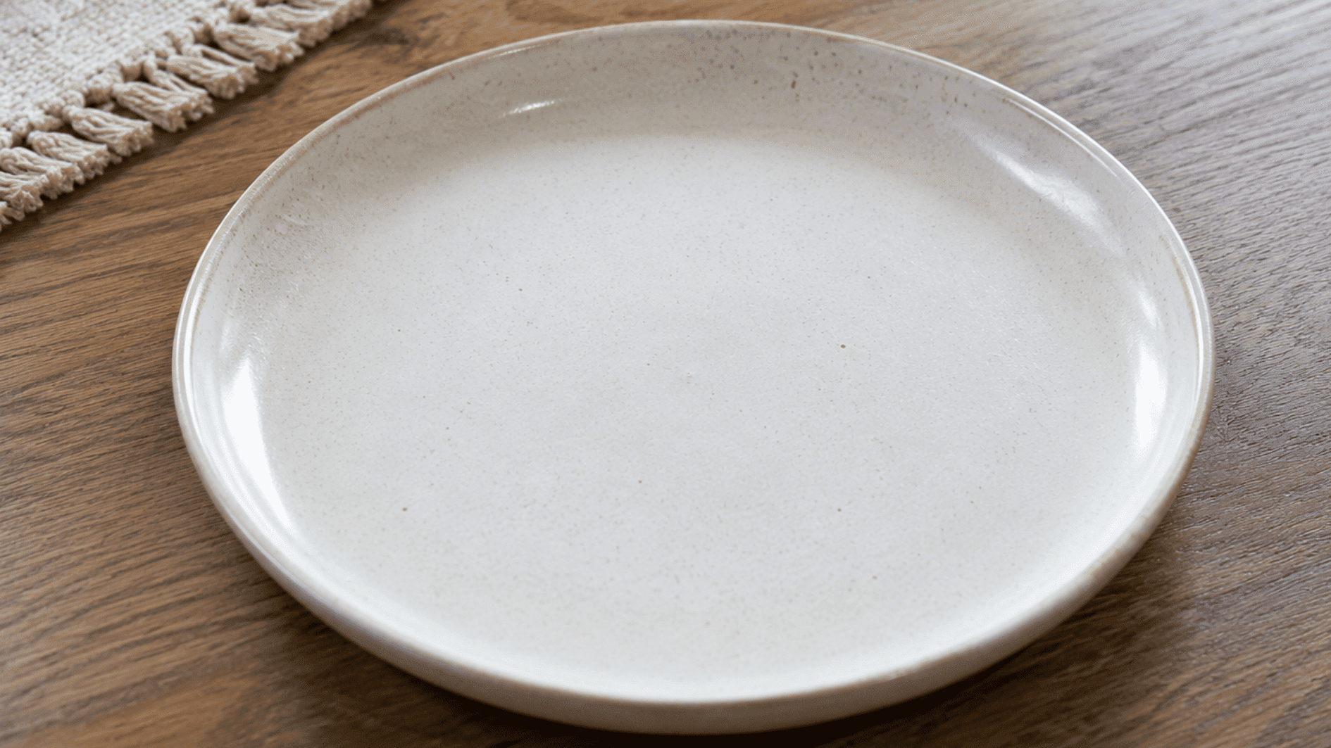 ceramic kids plate with colorful rim design holding food on a wooden table with a child friendly mealtime setup