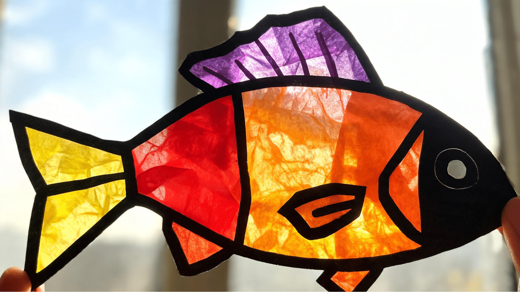 close up of orange and purple paper fish craft against sky (1)