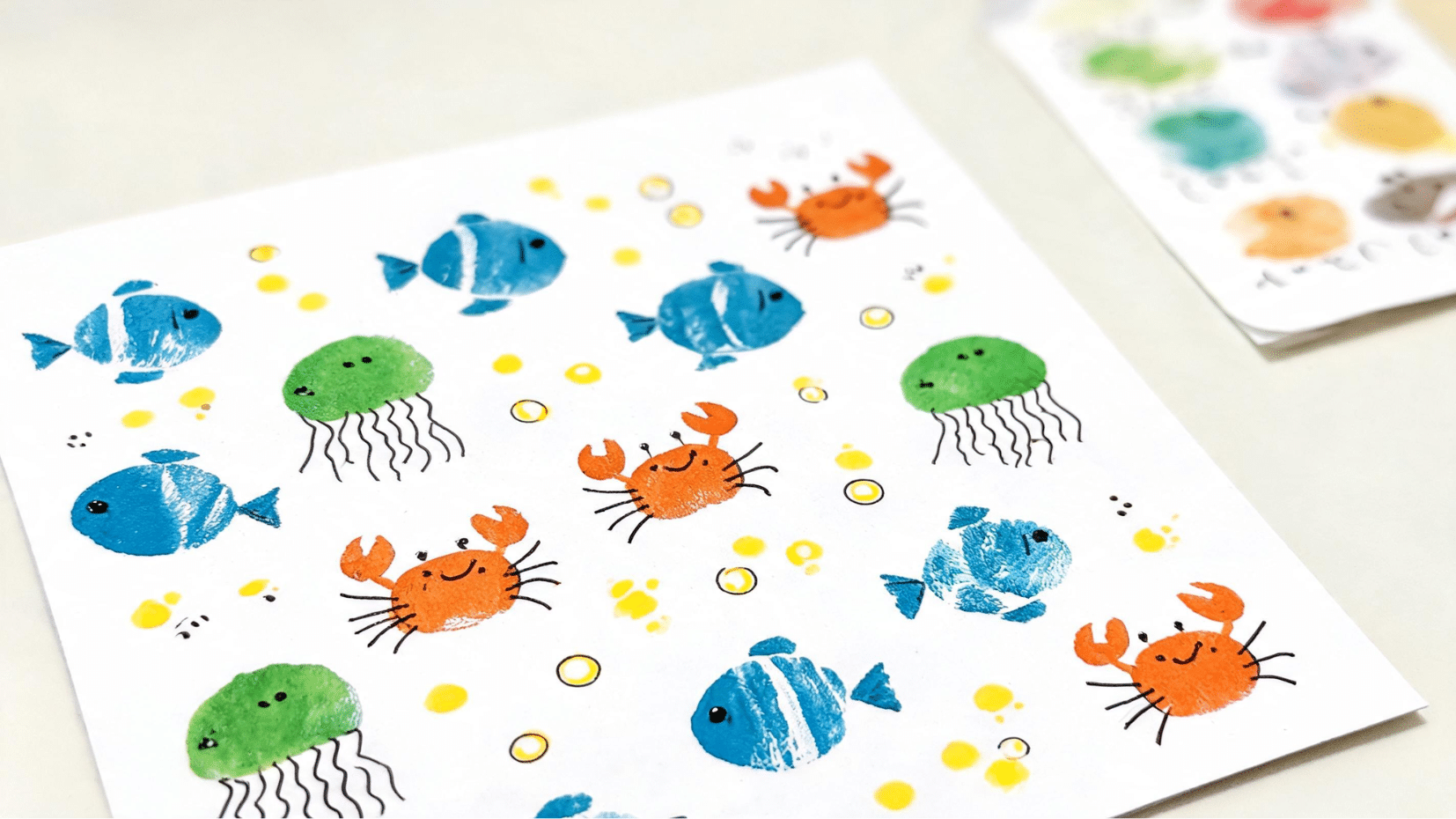 colorful kids craft with fish crabs jellyfish on white paper (1)