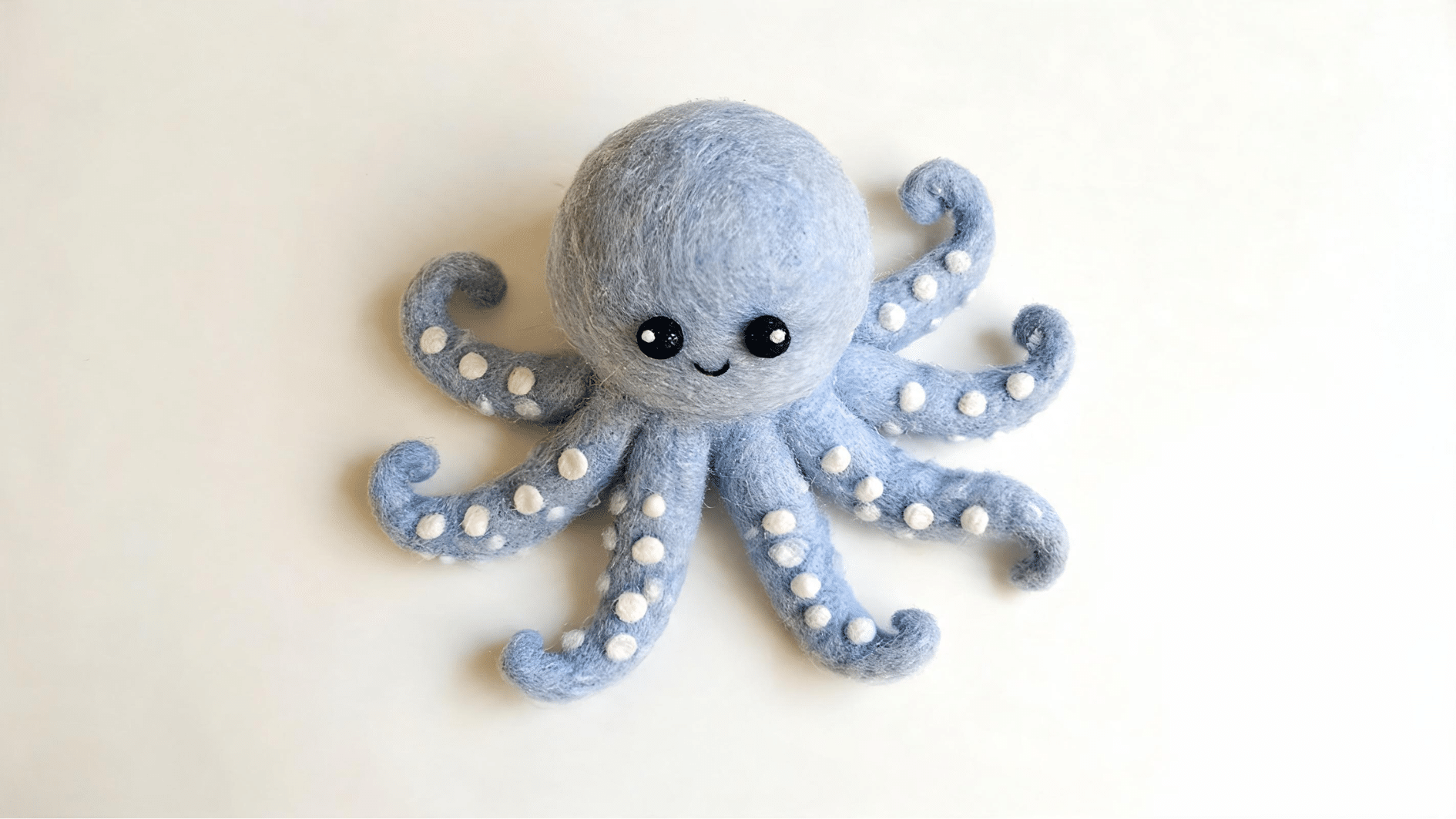 cute blue felt octopus toy with smiling face
