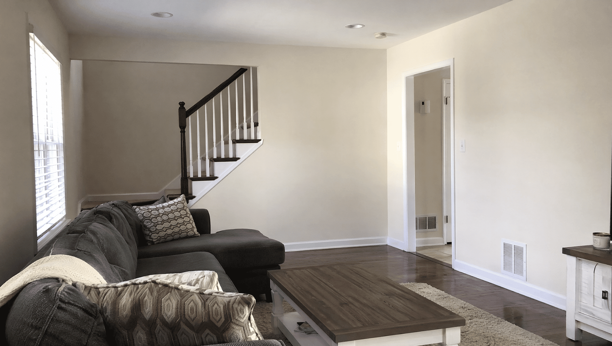 freshly painted neutral living room showing a budget friendly home renovation update with brighter walls and simple decor