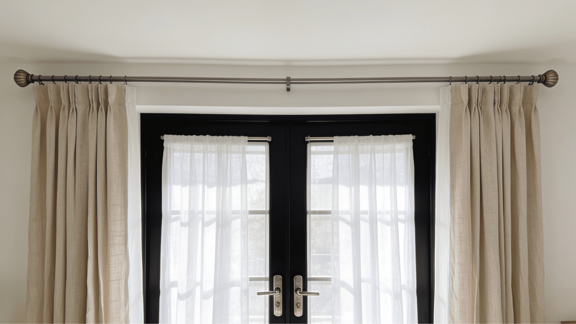 french doors with sheer curtains and outer drapes mounted above the frame for easy opening and layered window coverage