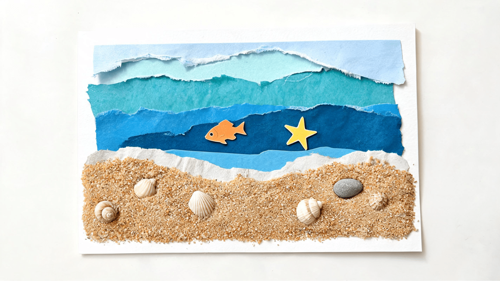 ocean scene with layered blue paper sand and small fis (1)