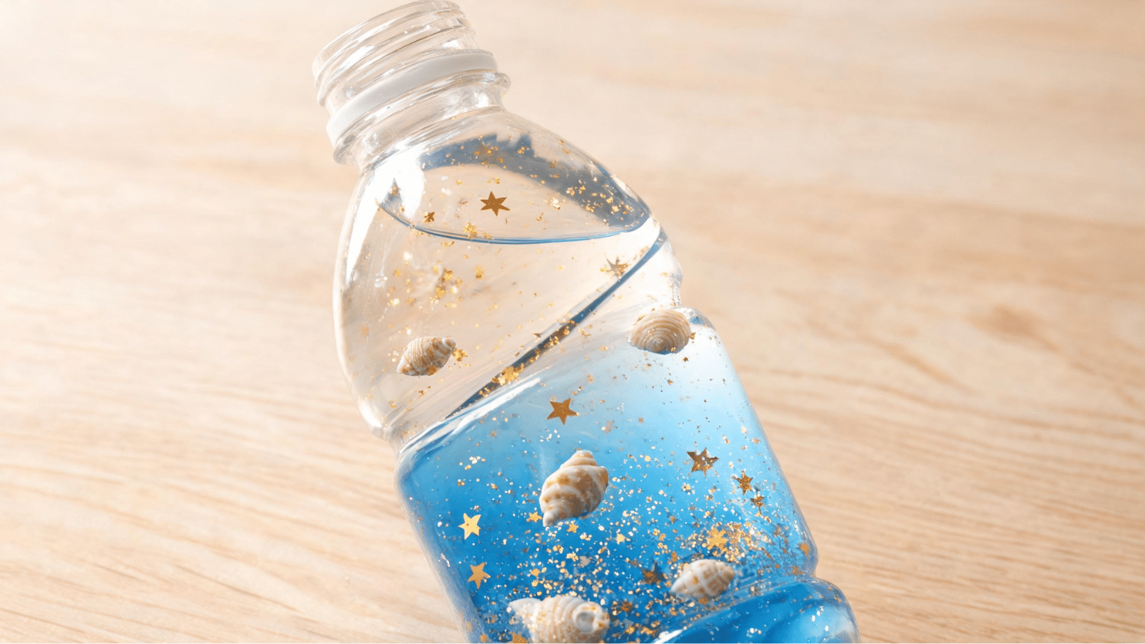plastic bottle craft with floating shells and glitter (1)