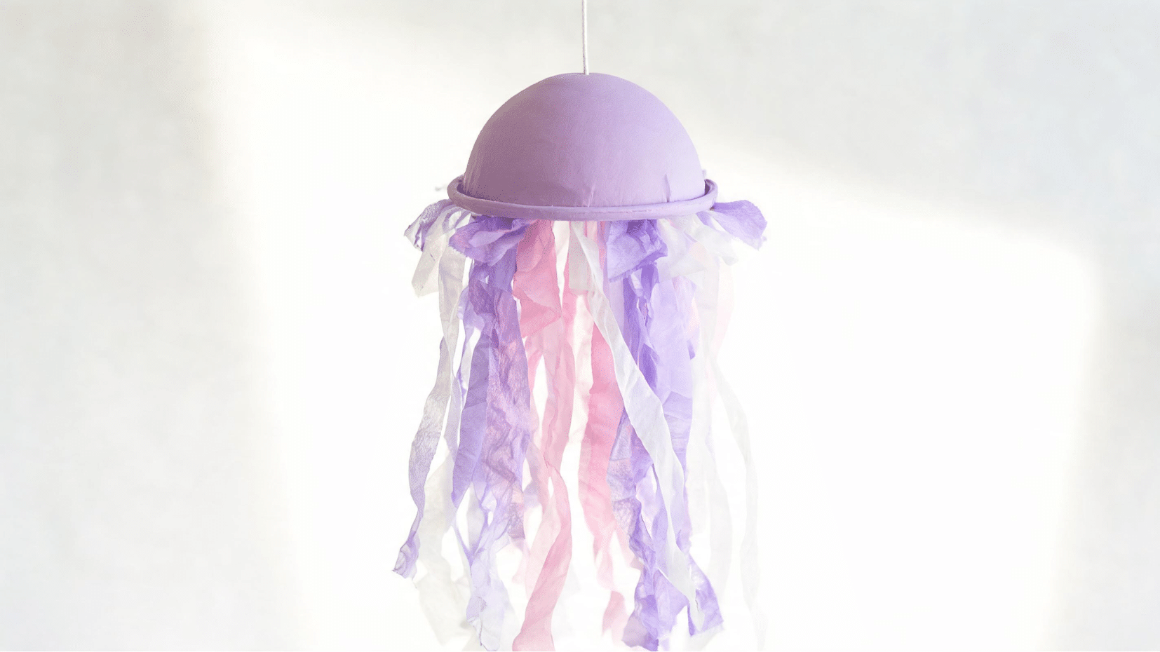 purple jellyfish hanging decoration with streamers on neutral background (1)