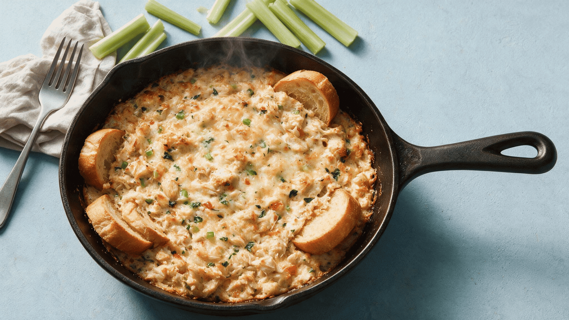 Baked crab dip with toast and celery