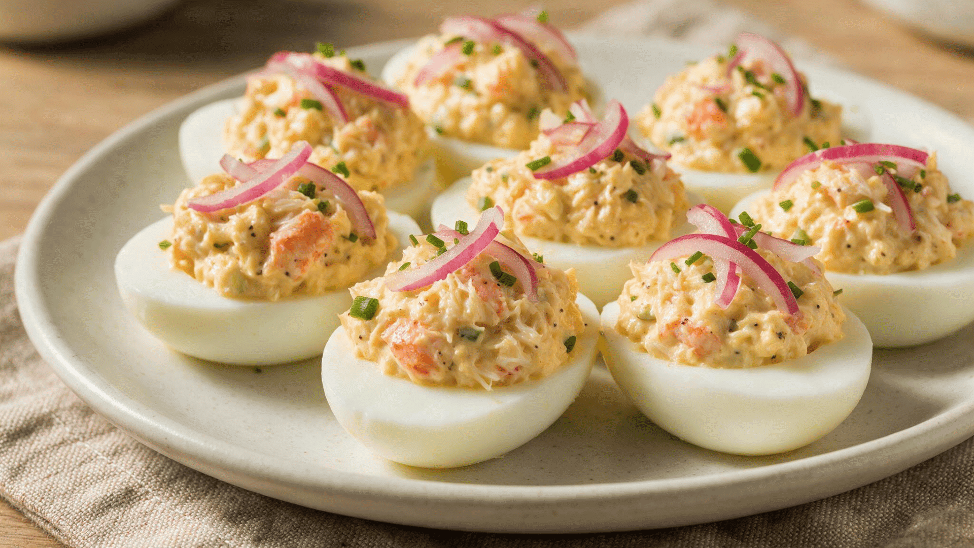 Crab deviled eggs on lemon slices with chives