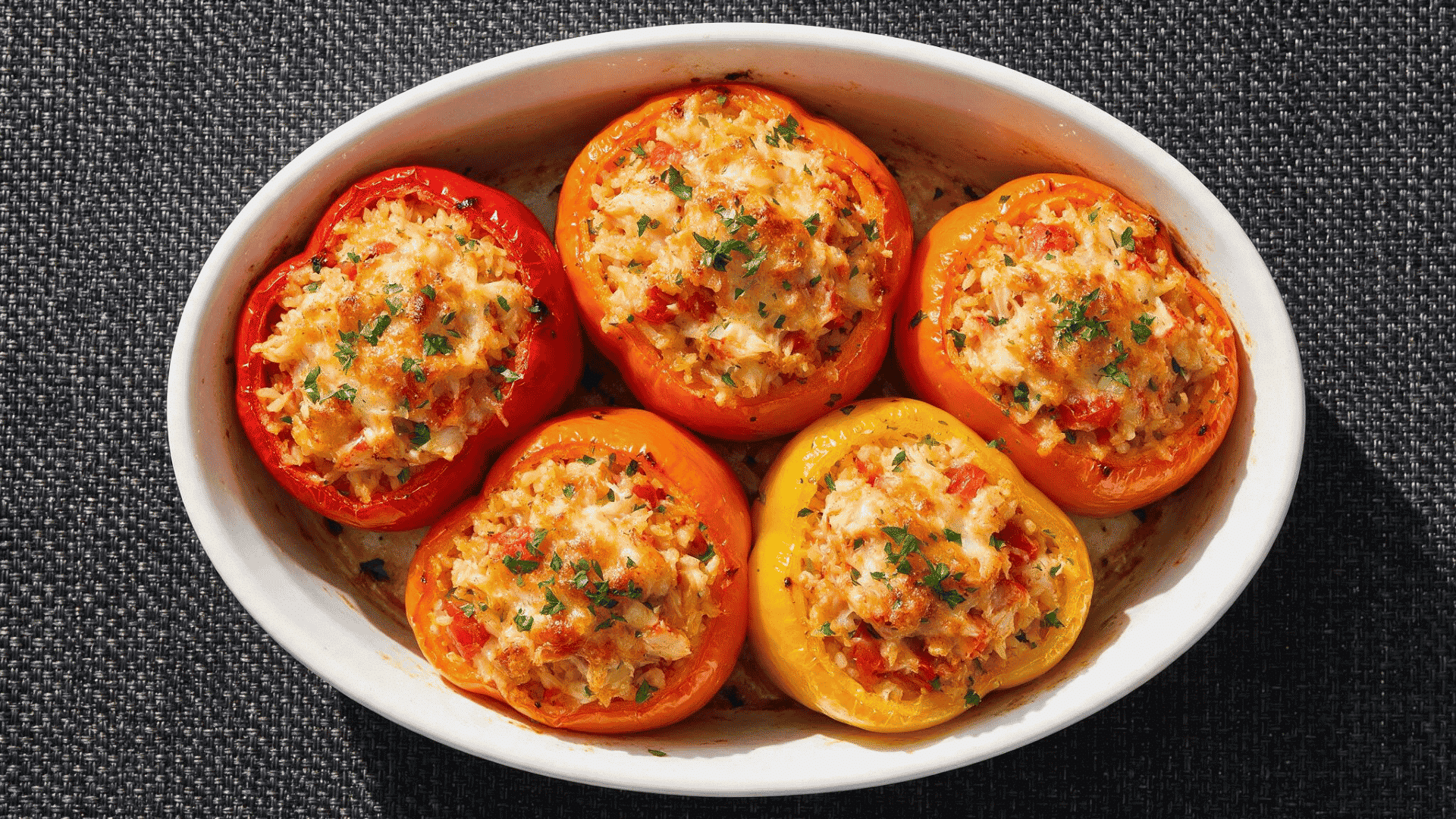 Crab stuffed bell peppers in a white baking dish