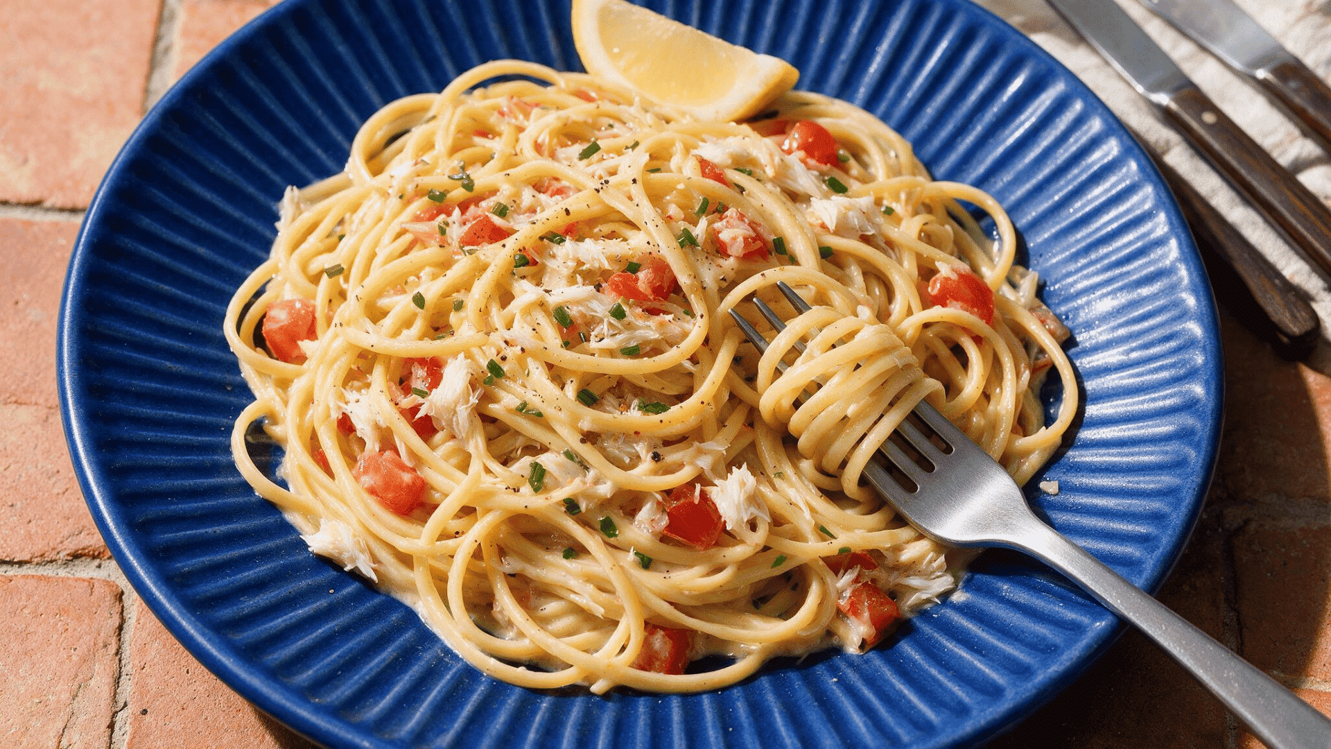 Creamy crab linguine pasta with tomatoes and lemon
