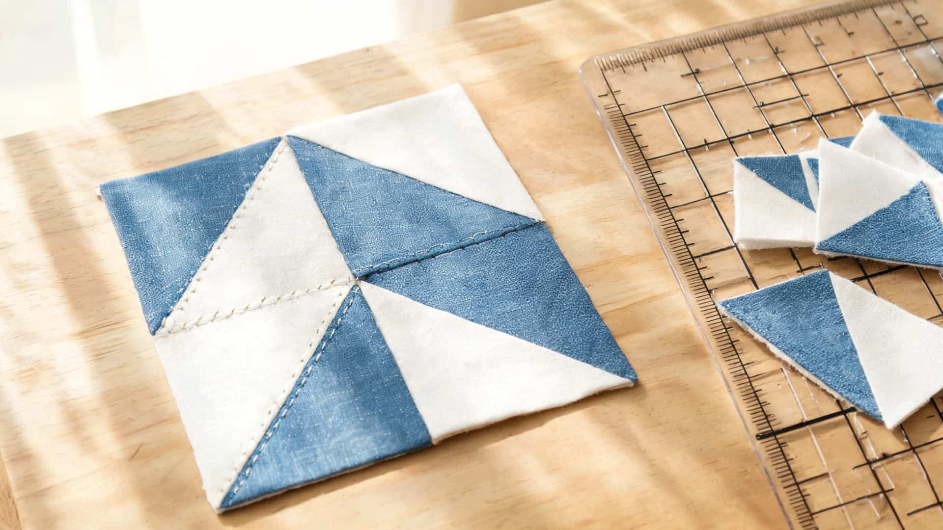 half square triangle quilt with blue and white triangles forming geometric quilt units