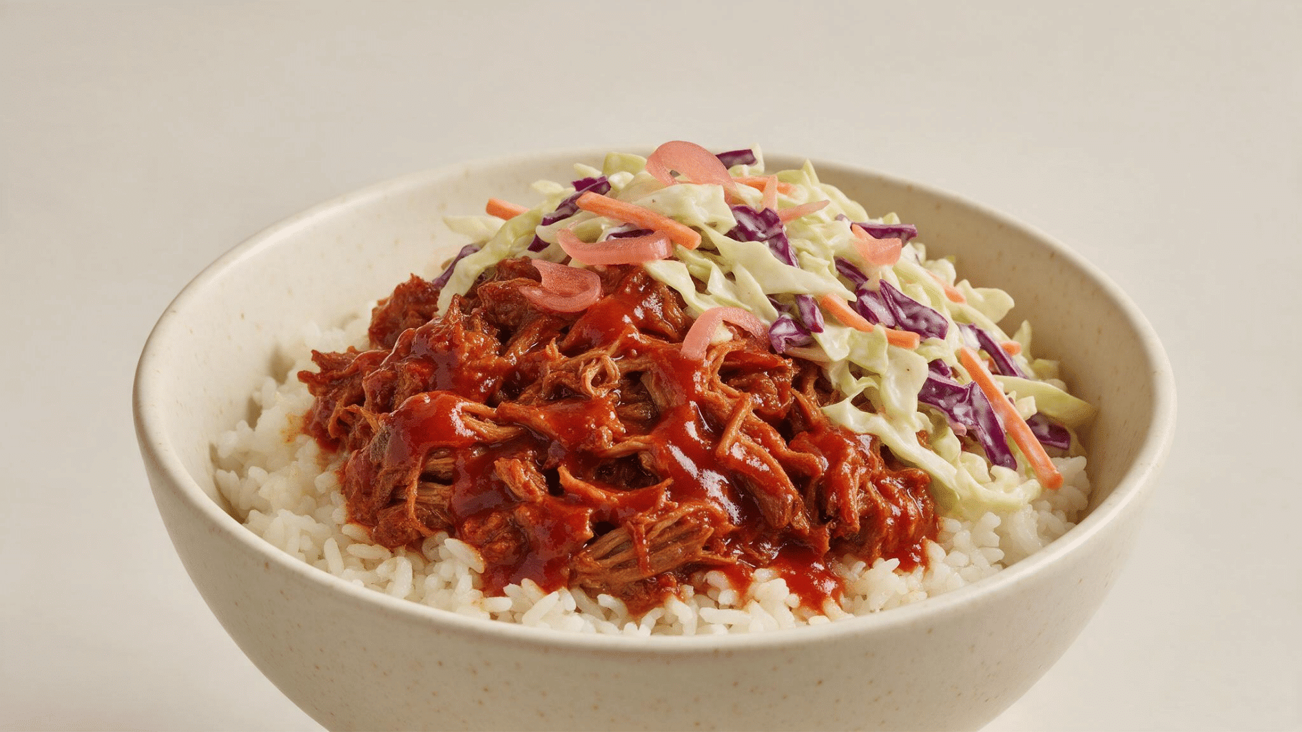 bbq pulled pork rice bowl with cabbage slaw carrots pickled onions and rice