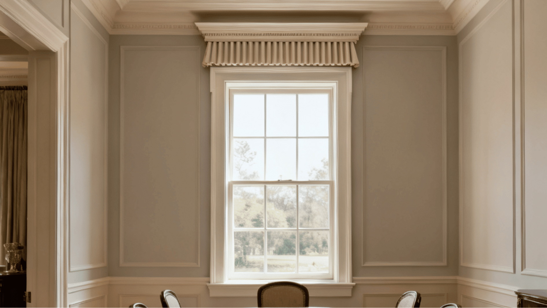 formal dining room with crown window trim featuring a decorative pediment above casing and detailed molding around window frame