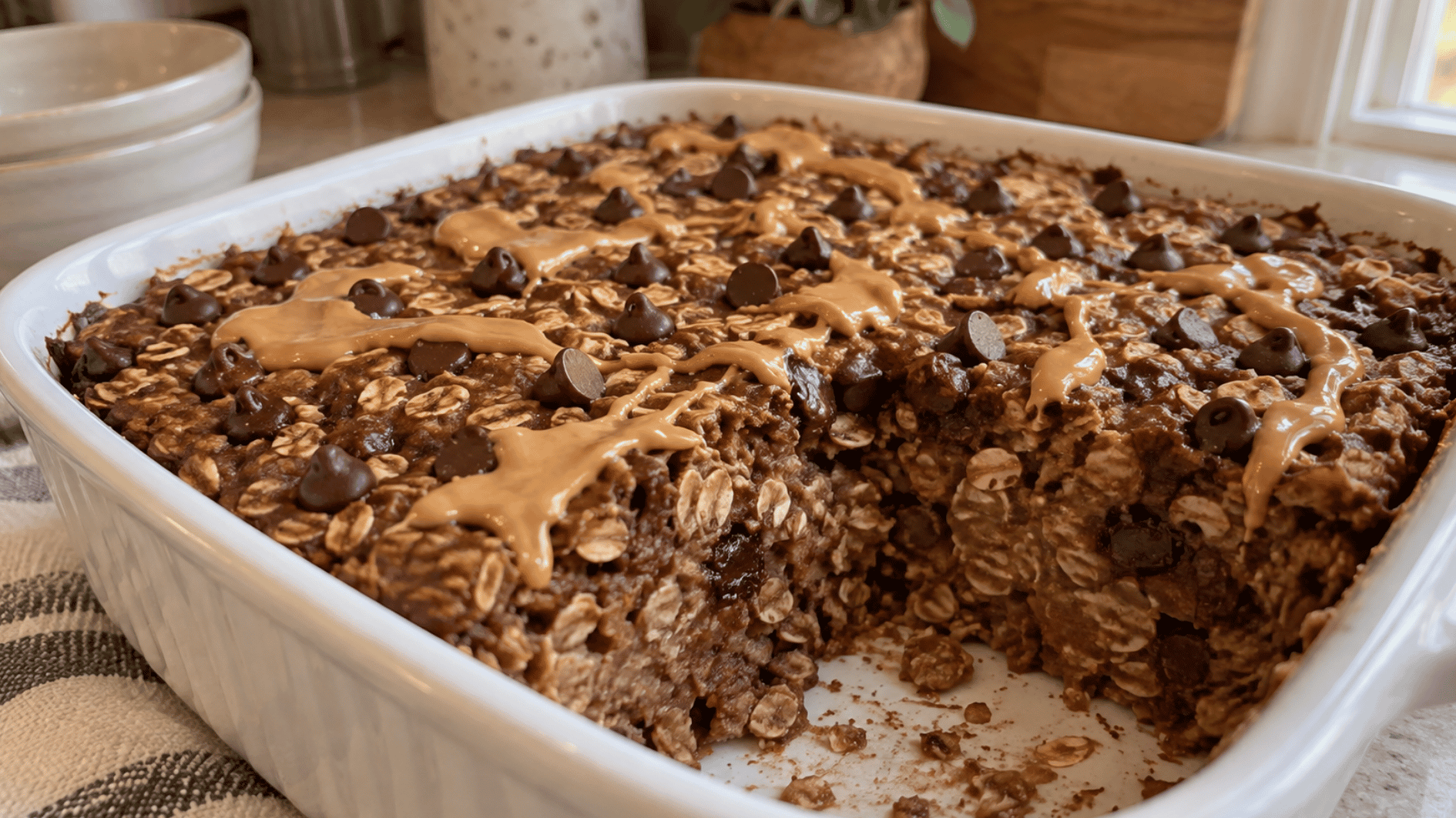 peanut butter chocolate baked oatmeal with visible oats chocolate chips and peanut butter topping
